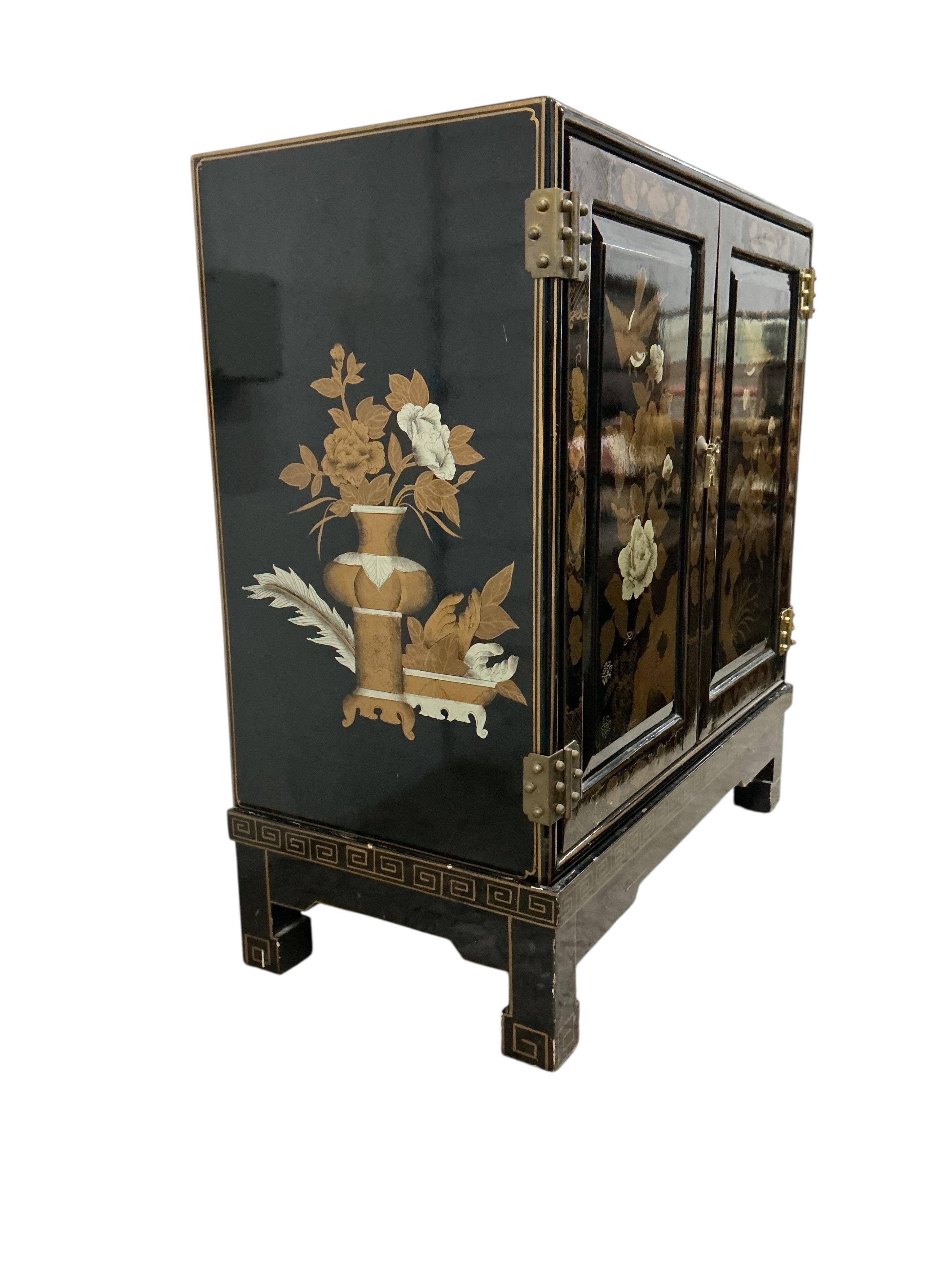 A small Chinese lacquered side cabinet, width 61cm, depth 30cm, height 67cm
